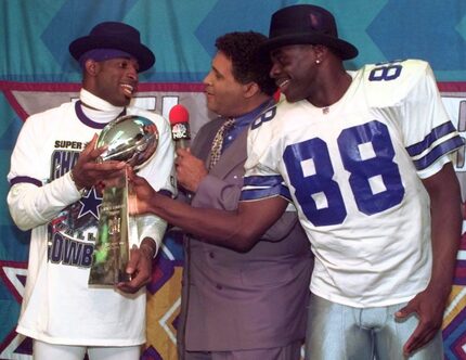 Dallas Cowboys cornerback Deion Sanders, left, and running back Michael Irvin (88) share the...