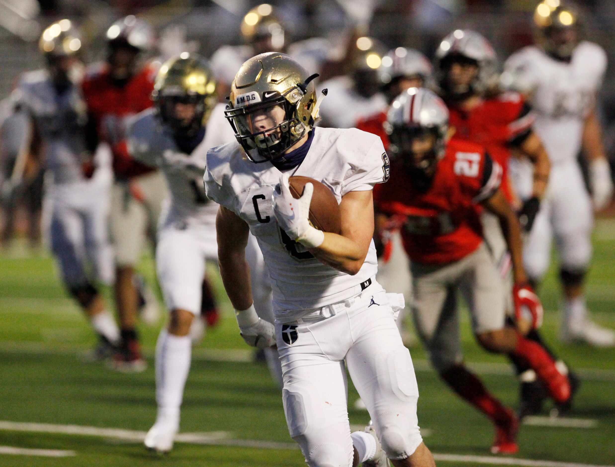 Jesuit senior running back Jake Taylor (8) moves for a big gain in yardage out running...