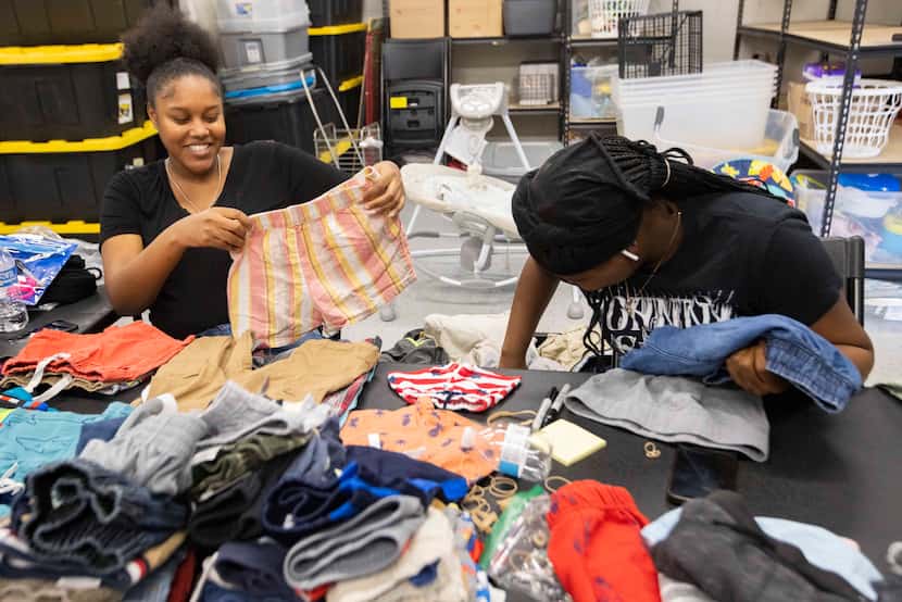 Residents Abigail Kelly (left) and Persia Johnson sort the clothing at Viola’s House on...