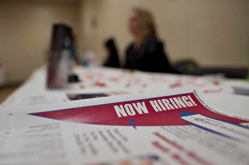 
Job seekers attend a job fair in Princeton, Ill.Hiring is picking up but wages remain...