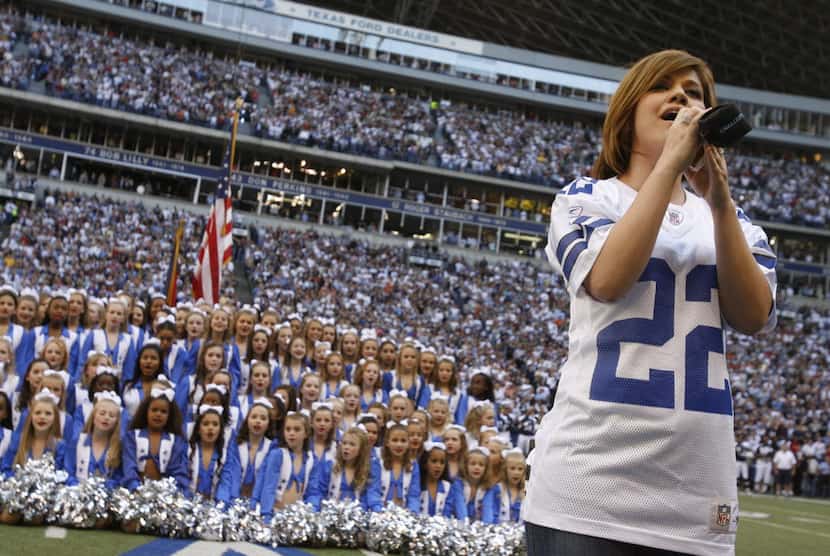 Singer Kelly Clarkson performs the national anthem before the first half of NFL football...