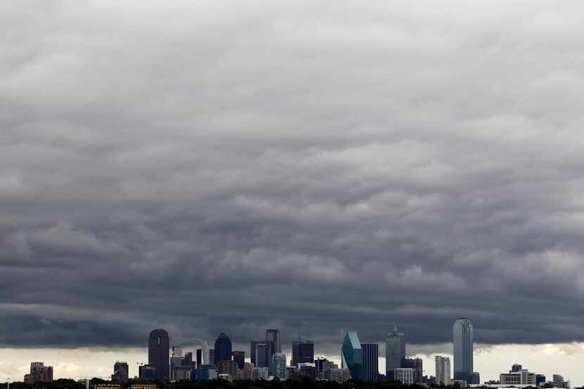 Dark clouds hang over the downtown Dallas skyline.