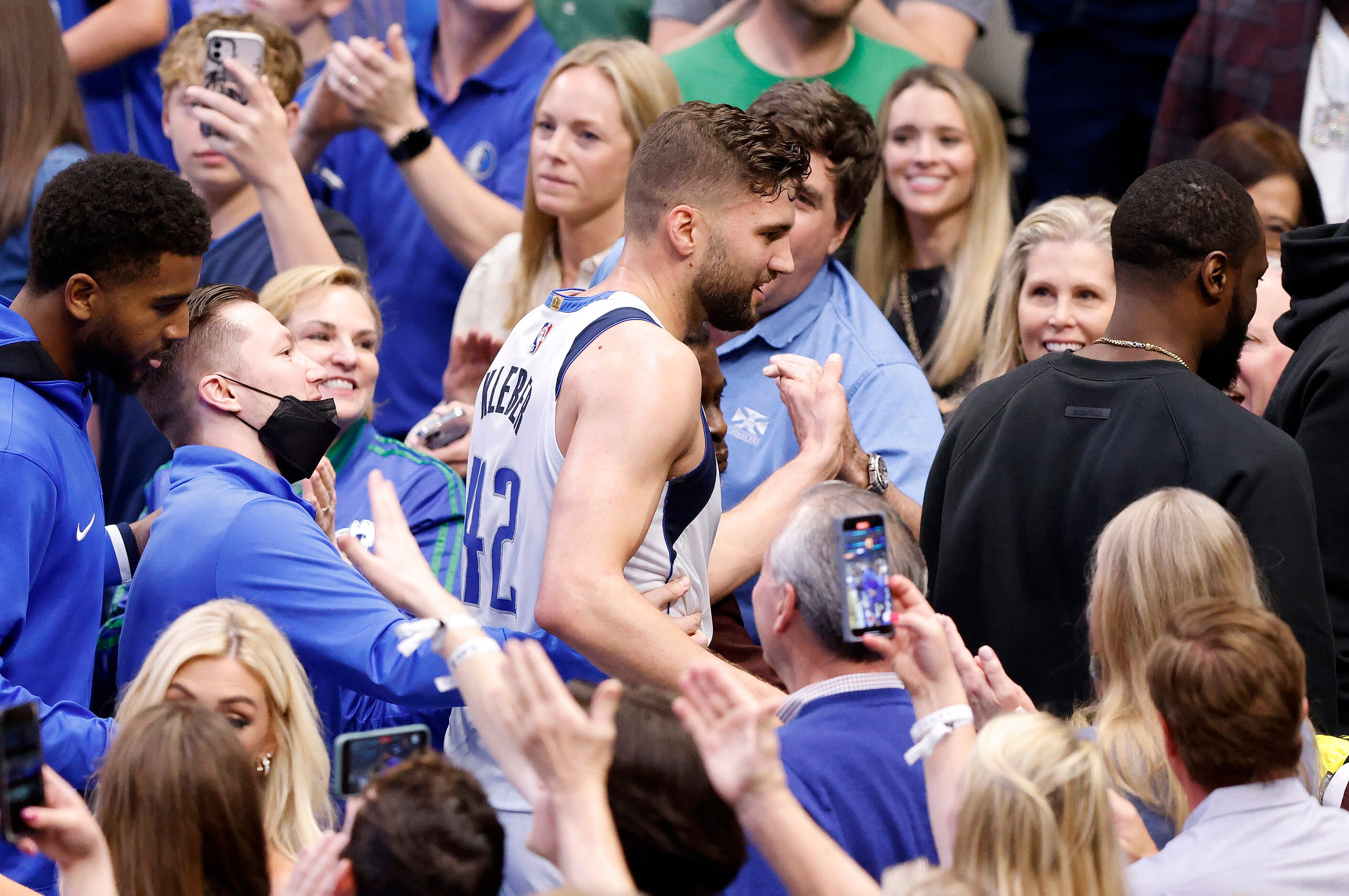 Dallas Mavericks forward Maxi Kleber (center) is congratulated by fans after their win over...