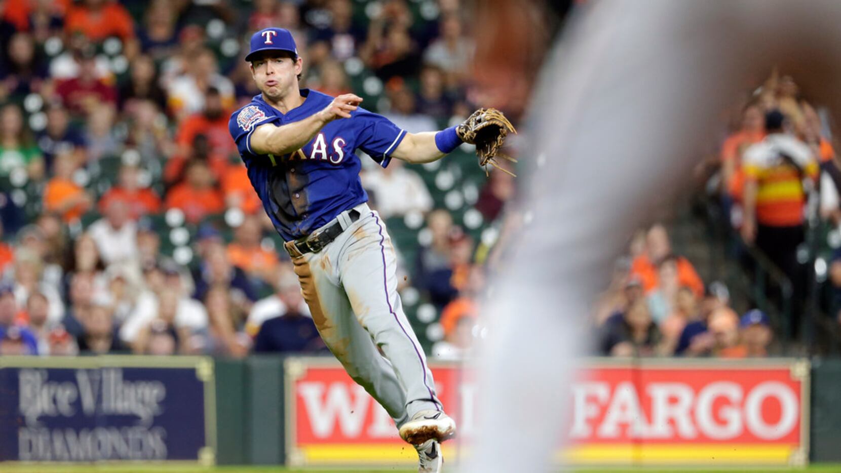 With the bases loaded and two out, Texas Rangers third baseman Nick Solak fields the hit by...
