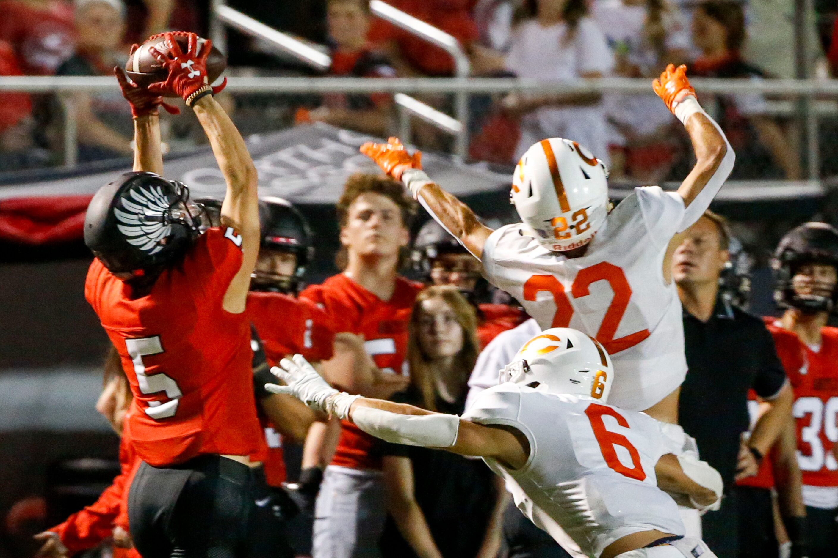 Argyle wide receiver Hayden Stewart (5) stretches to make a catch over Celina defensive...