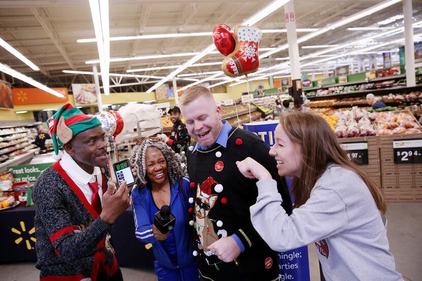 From left: Augustin Folly, grocery department manager, customer Trish Means of Dallas, Kevin...