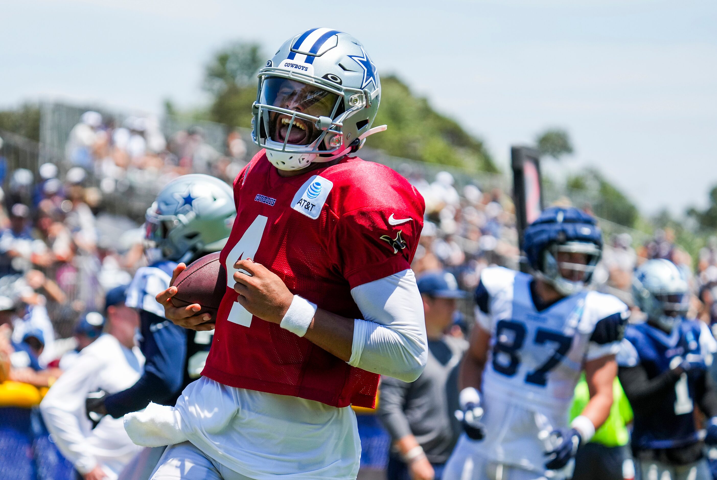 Dallas Cowboys quarterback Dak Prescott (4) celebrates as he runs for a touchdown during a...