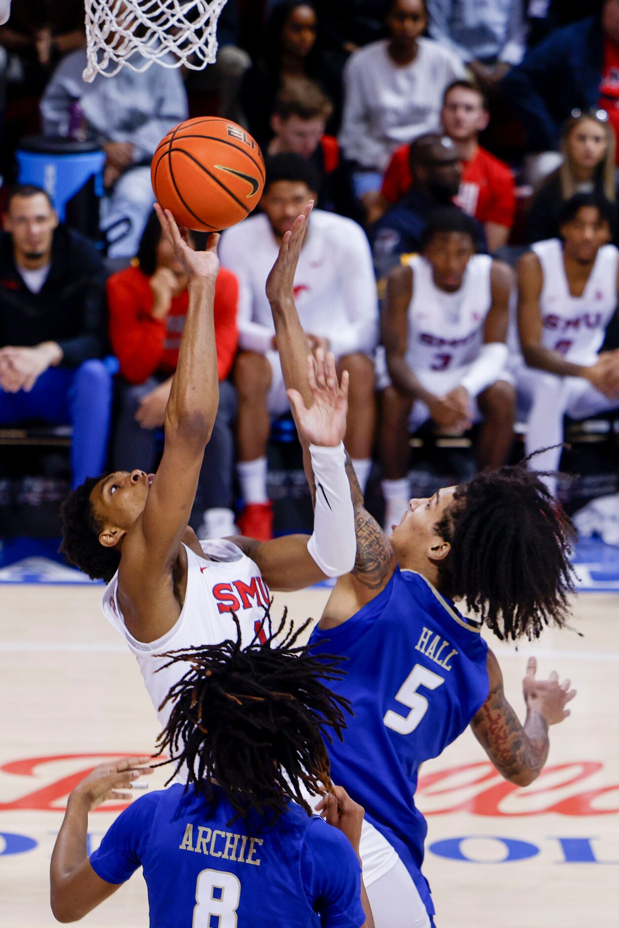 Southern Methodist guard Zhuric Phelps (back left) and Tulsa forward Jarred Hall reach for a...