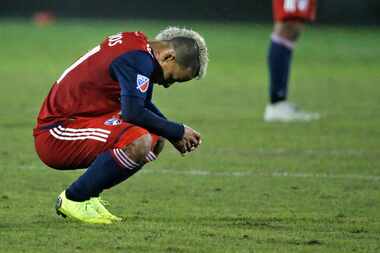 FC Dallas midfielder Michael Barrios (21) crouches dejectedly on the pitch after FC Dallas'...