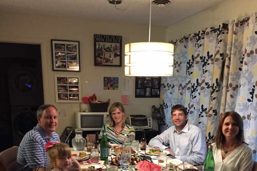 Attorney General Ken Paxton, far left, and his wife, Angela, far back, eat dinner on...