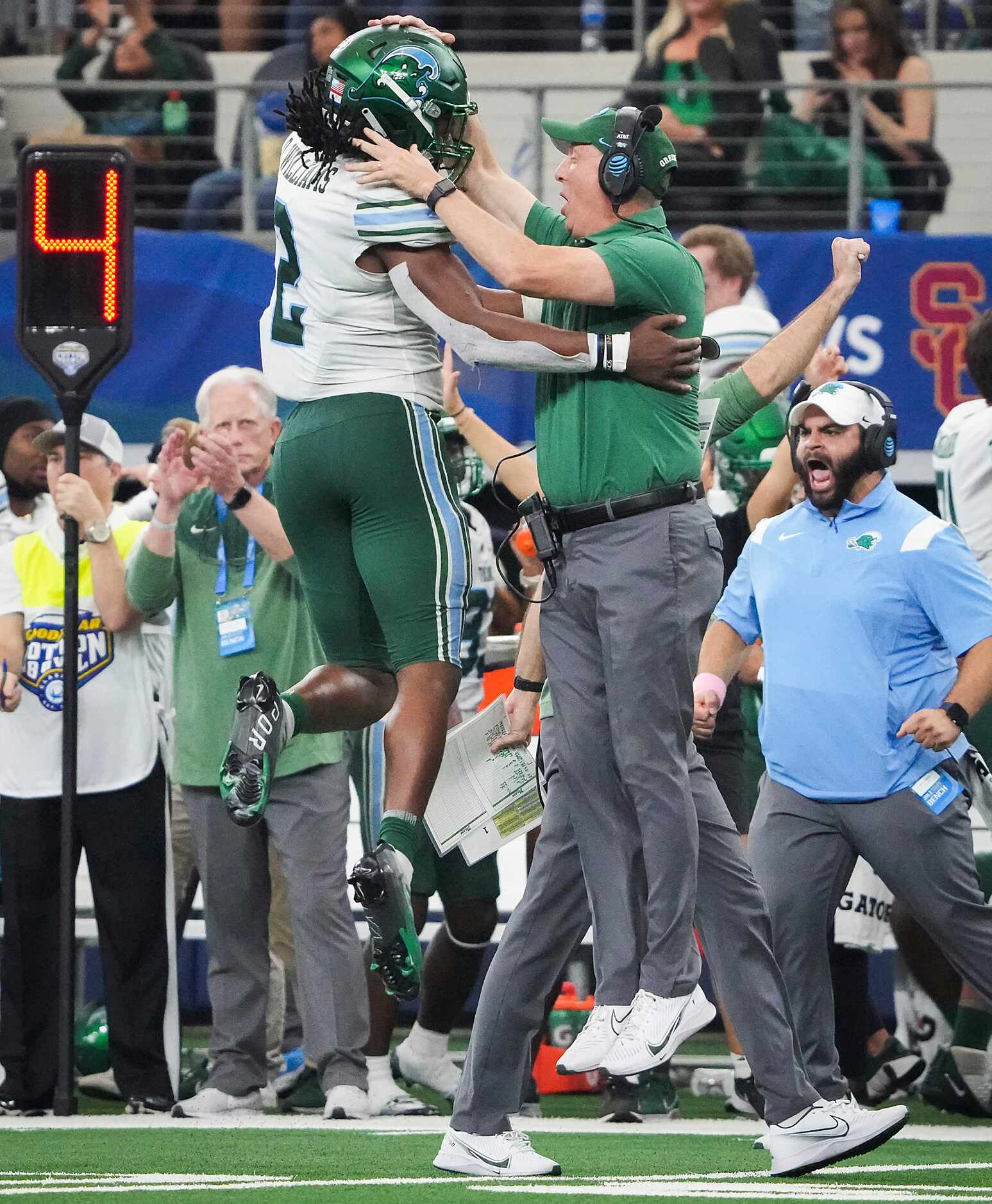 Tulane head coach Willie Fritz celebrates with linebacker Dorian Williams (2) after a missed...
