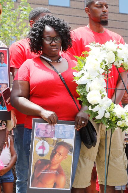 Charmaine Edwards and her husband, Odell Edwards, stand by a wreath placed on the steps of...