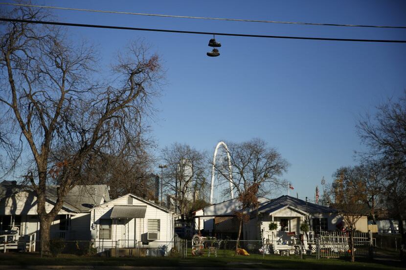 A pair of shoes hang from the power lines in the La Bajada neighborhood in West Dallas,...