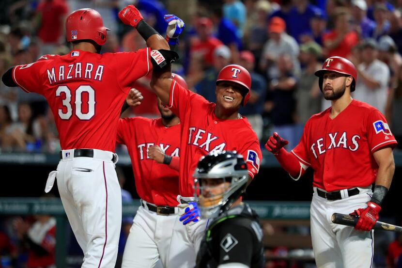 ARLINGTON, TX - AUGUST 17:  Nomar Mazara #30 of the Texas Rangers celebrates with Elvis...