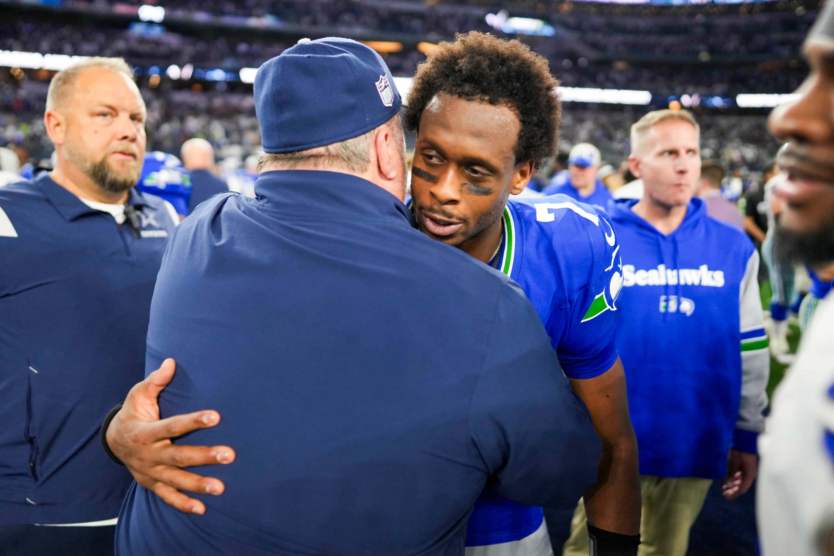 Seattle Seahawks quarterback Geno Smith  hugs Dallas Cowboys head coach Mike McCarthy after...