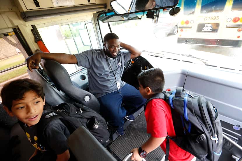 Richardson ISD school bus driver Curtis Jenkins greets students as they board after...