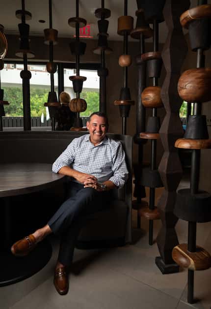 Mi Cocina CEO Edgar Guevara sits beside the "totems" on both floors of the new Mi Cocina on...