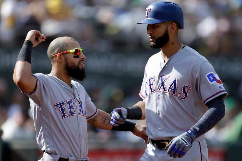 Texas Rangers' Nomar Mazara, right, celebrates with Rougned Odor after hitting a home run...