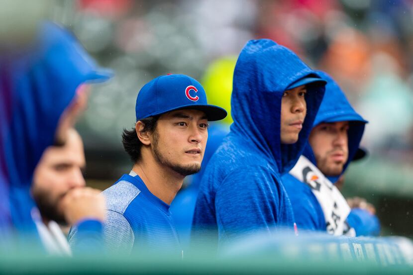 CLEVELAND, OH - APRIL 24: Pitcher Yu Darvish #11 of the Chicago Cubs talks with teammates in...