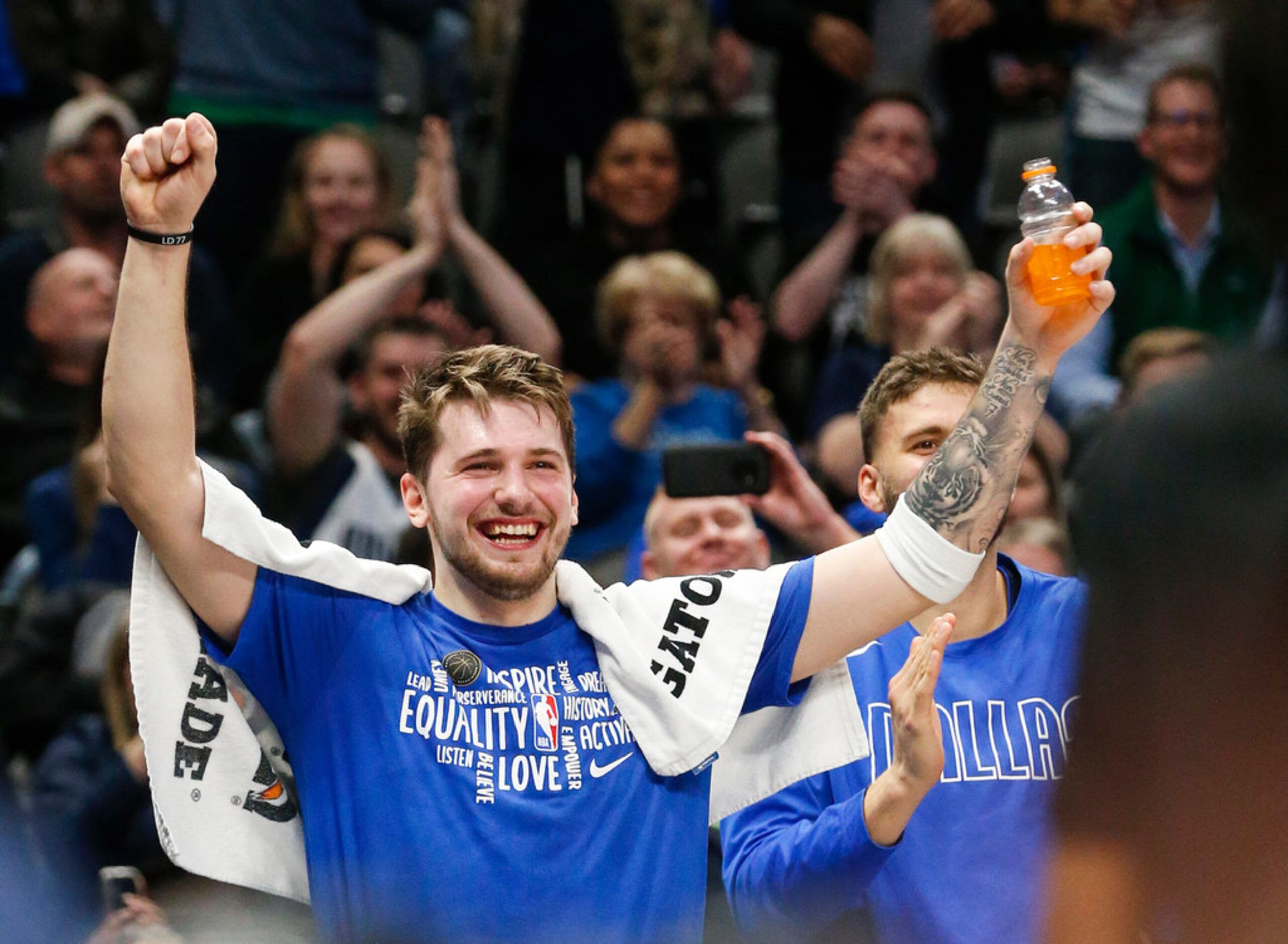 Dallas Mavericks guard Luka Doncic (77) celebrates as center Boban Marjanovic (51) breaks...