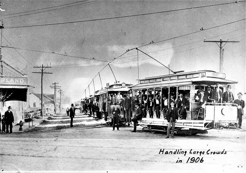 Streetcars filled up with passengers during the 1906 State Fair of Texas. Trolleys were...