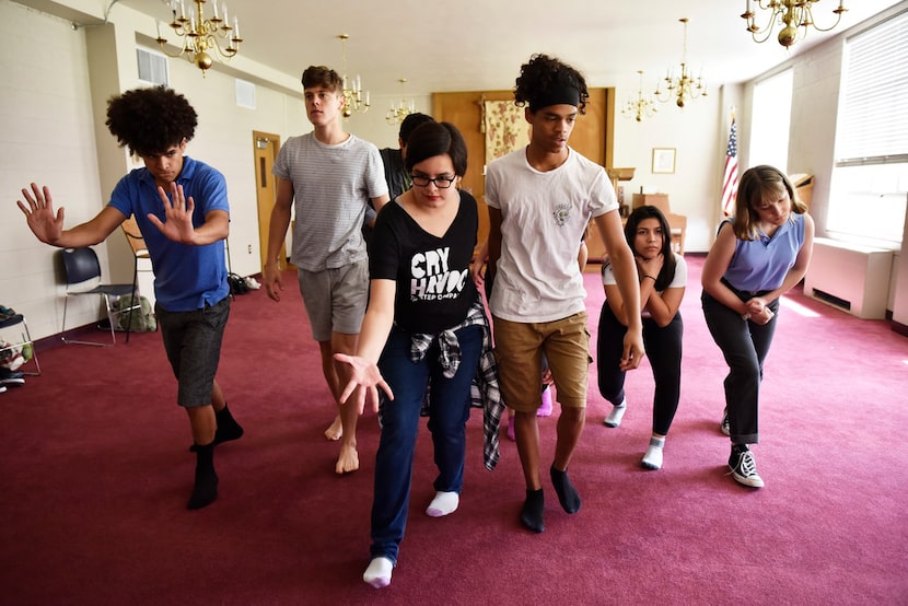 Laurel Mora, 17, (center left) and Matthew Gardara, 17, (center right) lead a group of high...