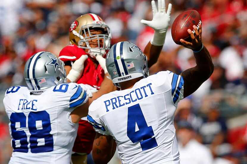 Dallas Cowboys quarterback Dak Prescott (4) releases a in the second quarter pass as he gets...