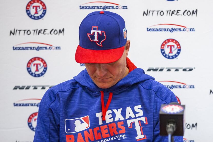 Texas Rangers manager Jeff Banister looks down while discussing the cancer diagnosis of...