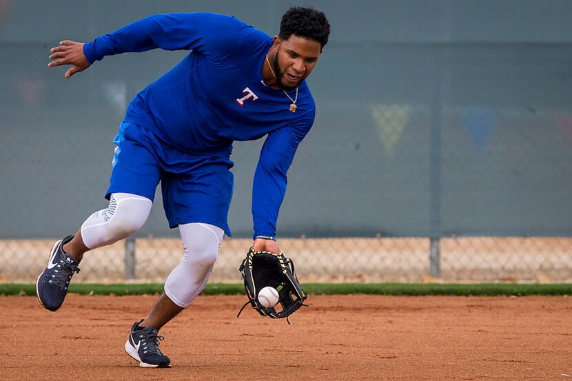 Texas Rangers shortstop Elvis Andrus takes infield practice during a spring training workout...