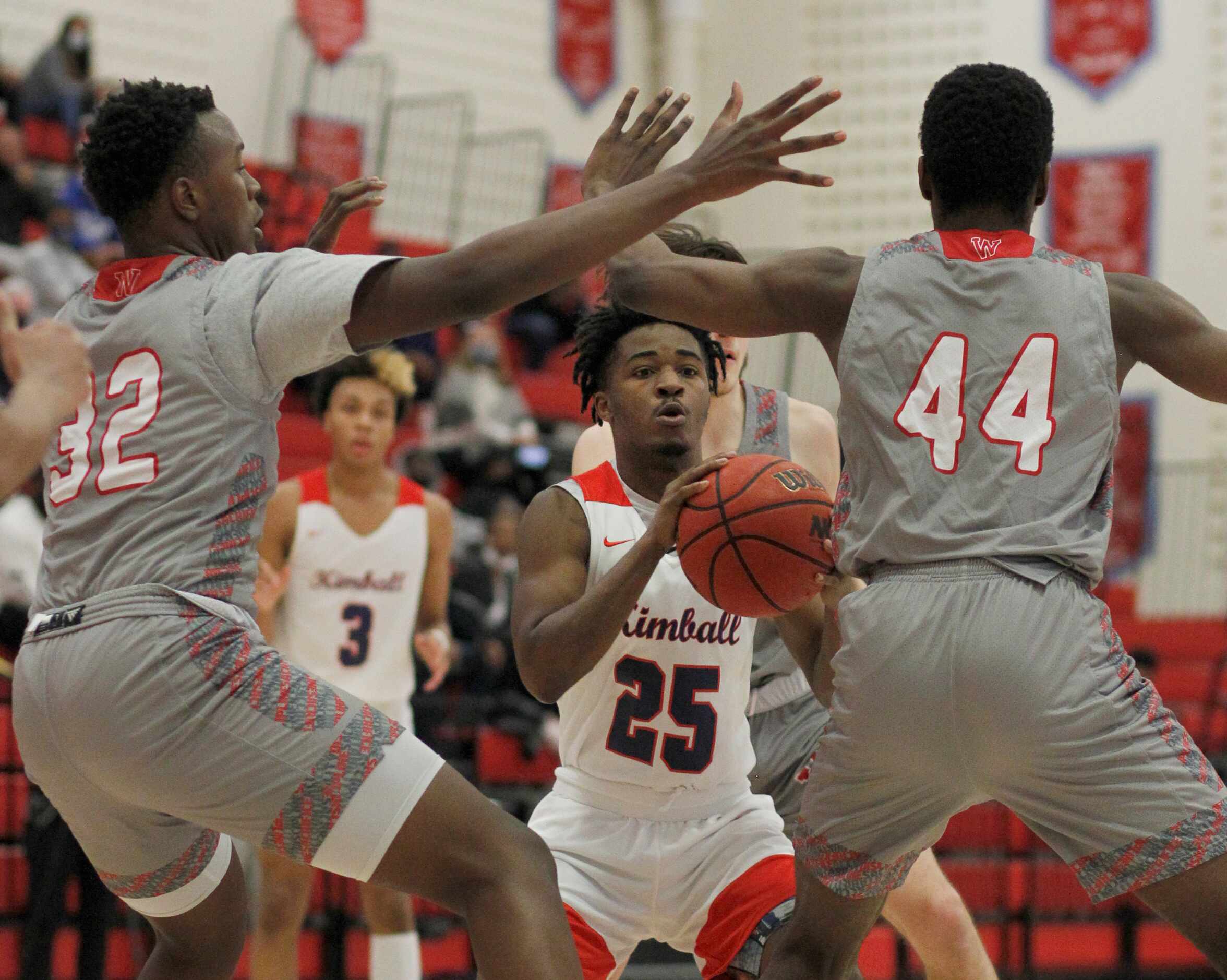Dallas Kimball guard Jerqualen Parks (25) is surrounded by Dallas Woodrow Wilson defenders...