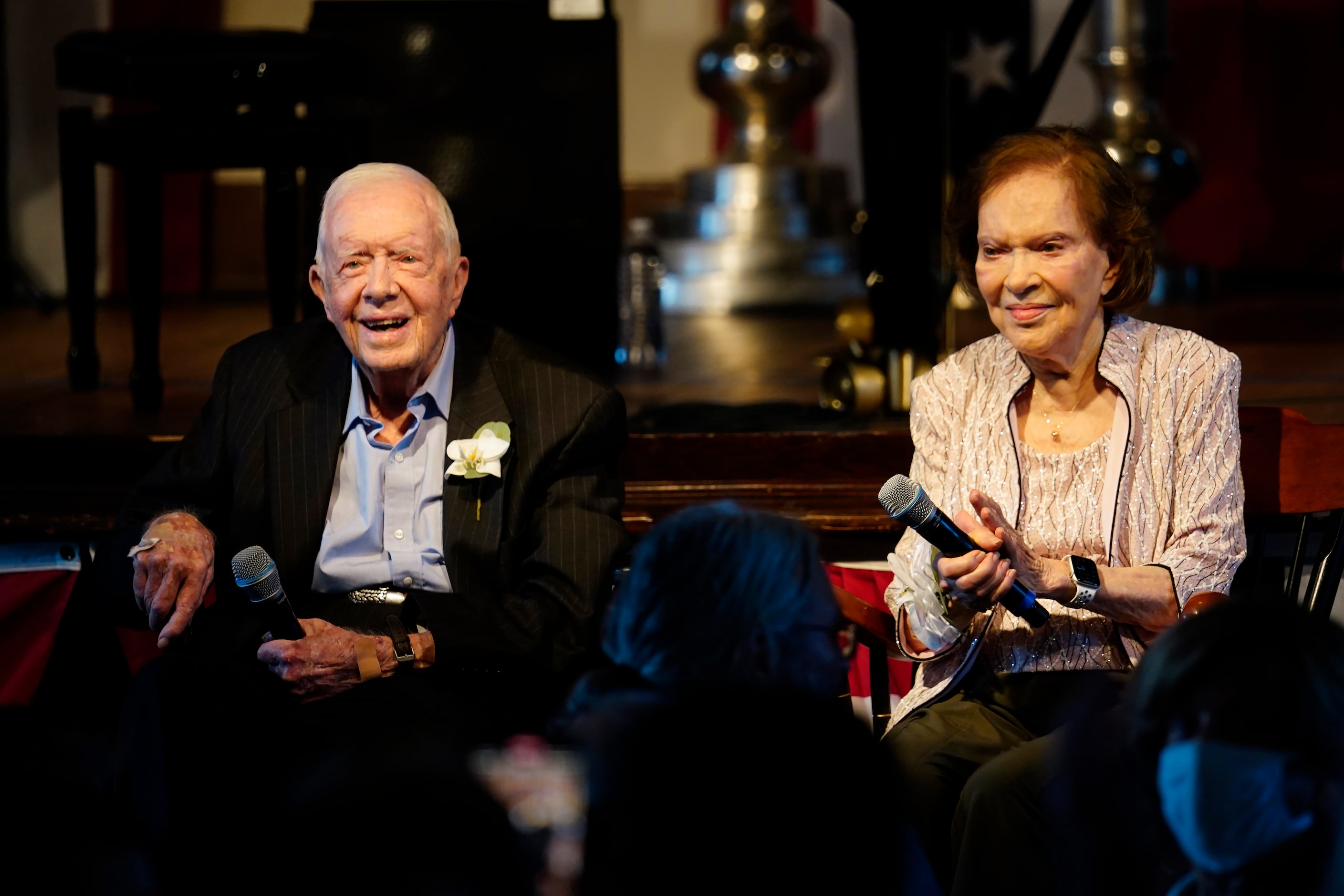 Former President Jimmy Carter and his wife former First Lady Rosalynn Carter sit together...