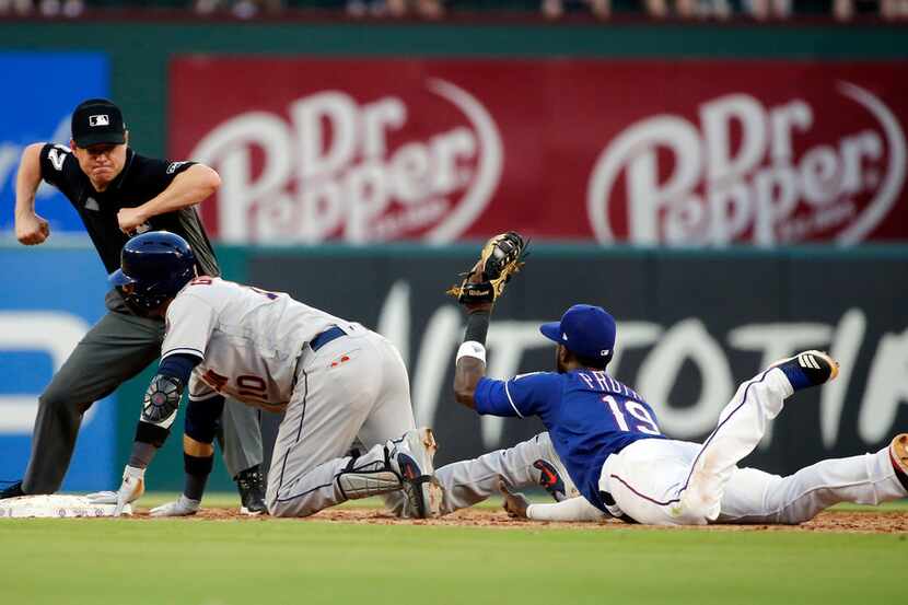 Houston Astros' Yuli Gurriel looks for the call as Texas Rangers shortstop Jurickson Profar...