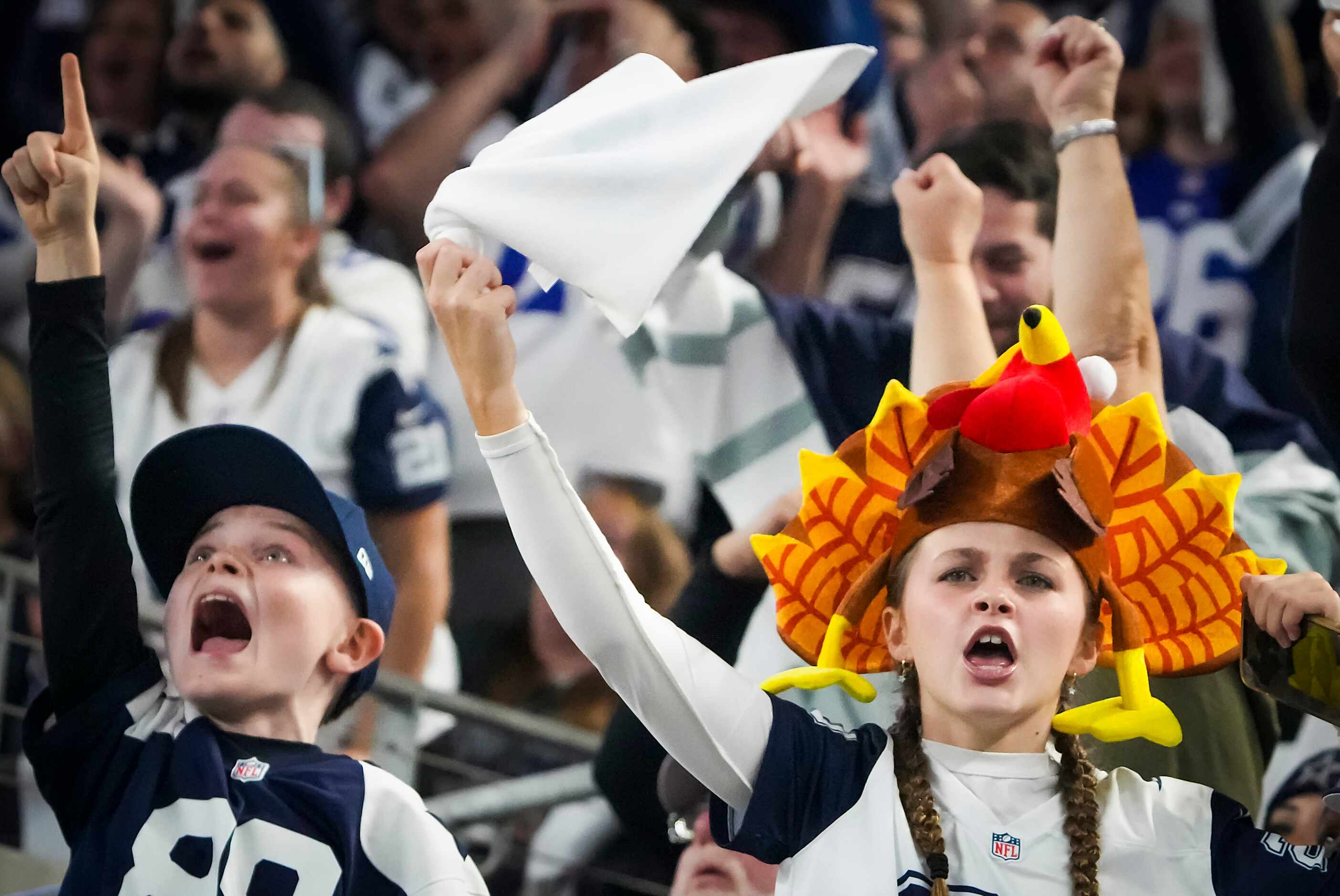 Dallas Cowboys fans celebrate a defensive stop during the second half of an NFL football...