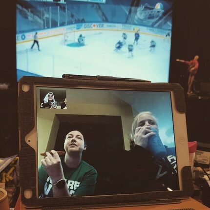 Amy Braid (left) eats a pizza while watching the Stanley Cup finals with Alison Eldridge....