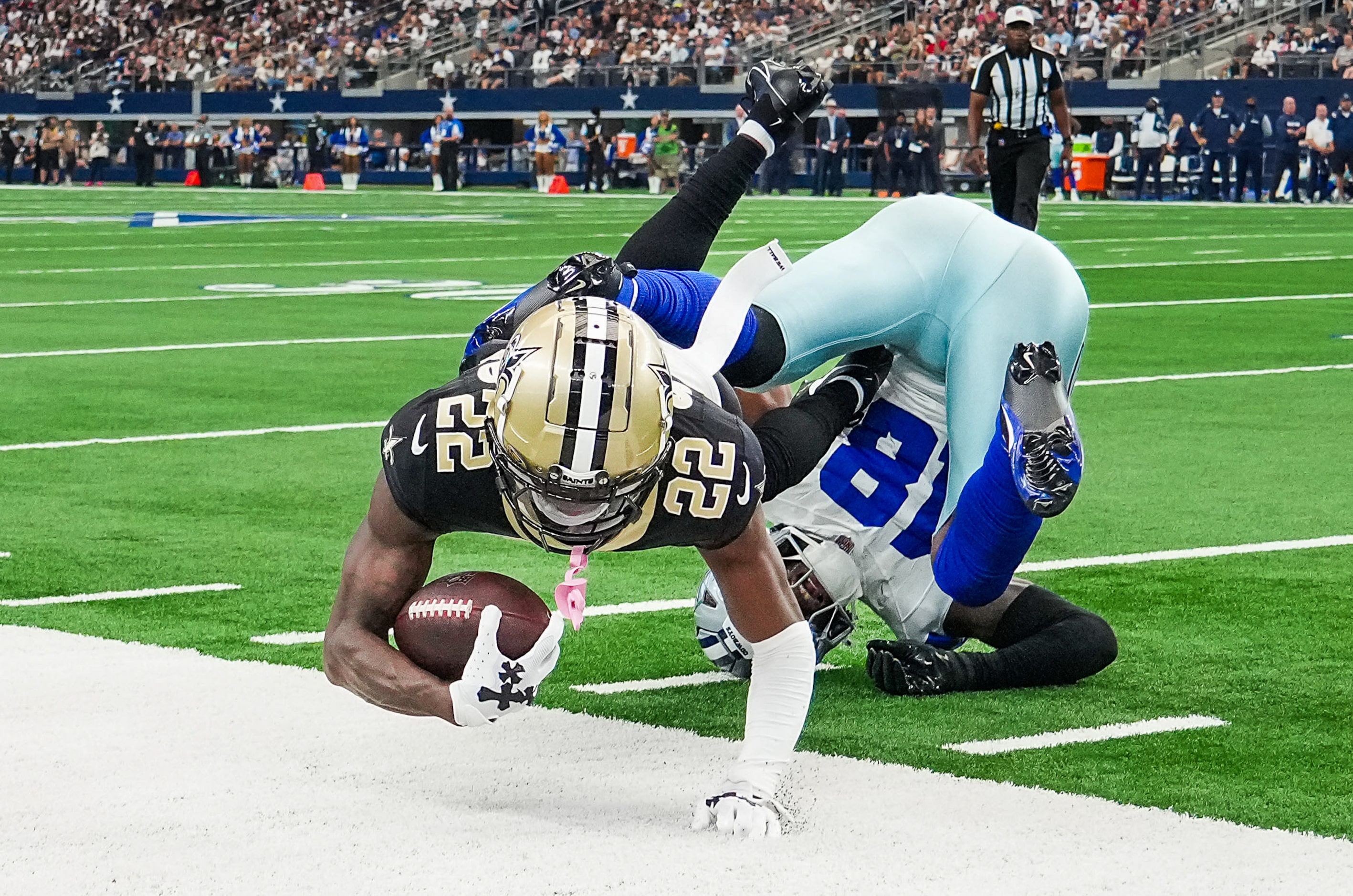 New Orleans Saints wide receiver Rashid Shaheed (22) tumbles out of bounds over Dallas...