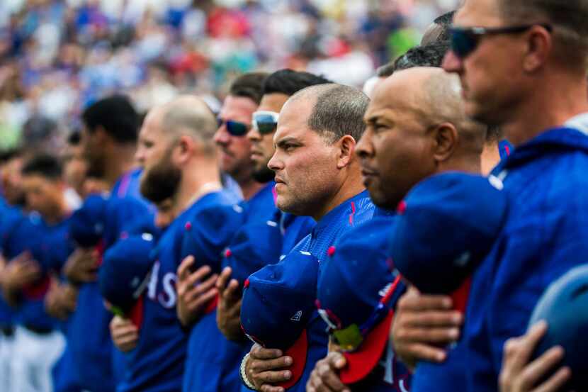 MLB Hall of Fame catcher Ivan "Pudge" Rodriguez, center, stands with the Rangers during the...