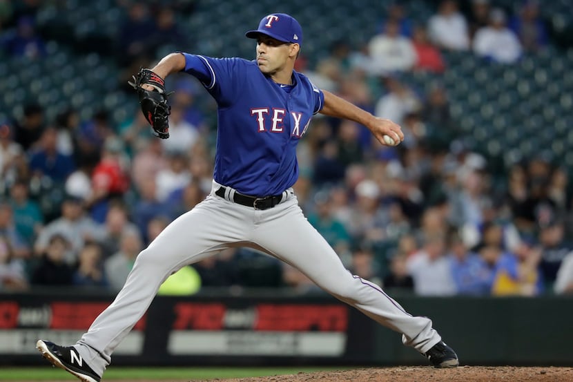 Texas Rangers relief pitcher Brandon Mann throws against the Seattle Mariners in the fourth...
