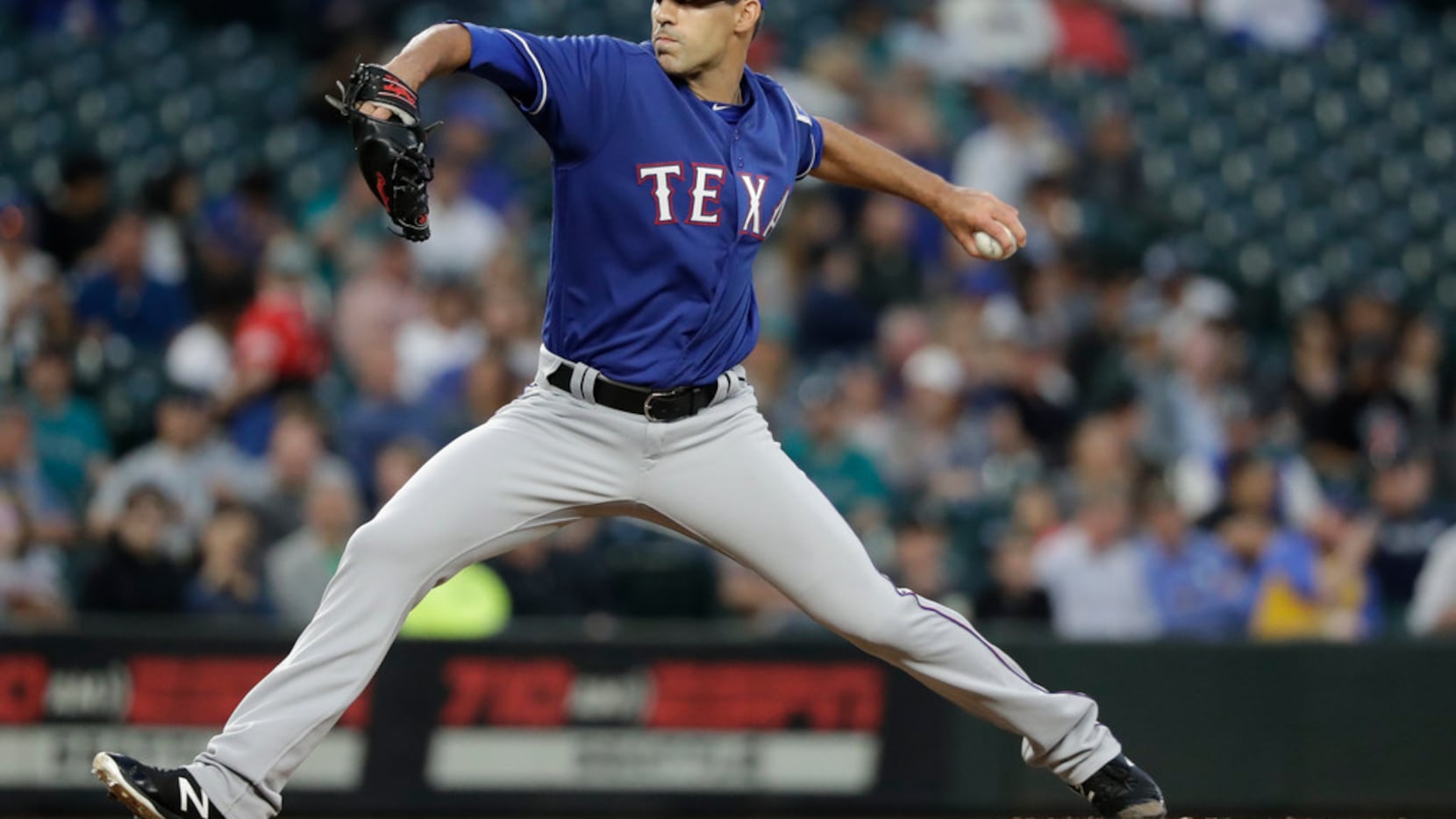 Texas Rangers relief pitcher Brandon Mann throws against the Seattle Mariners in the fourth...