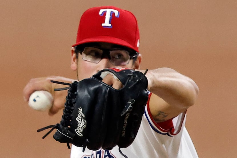 Texas Rangers starting pitcher Dane Dunning (33) throws against the Los Angeles Angels...