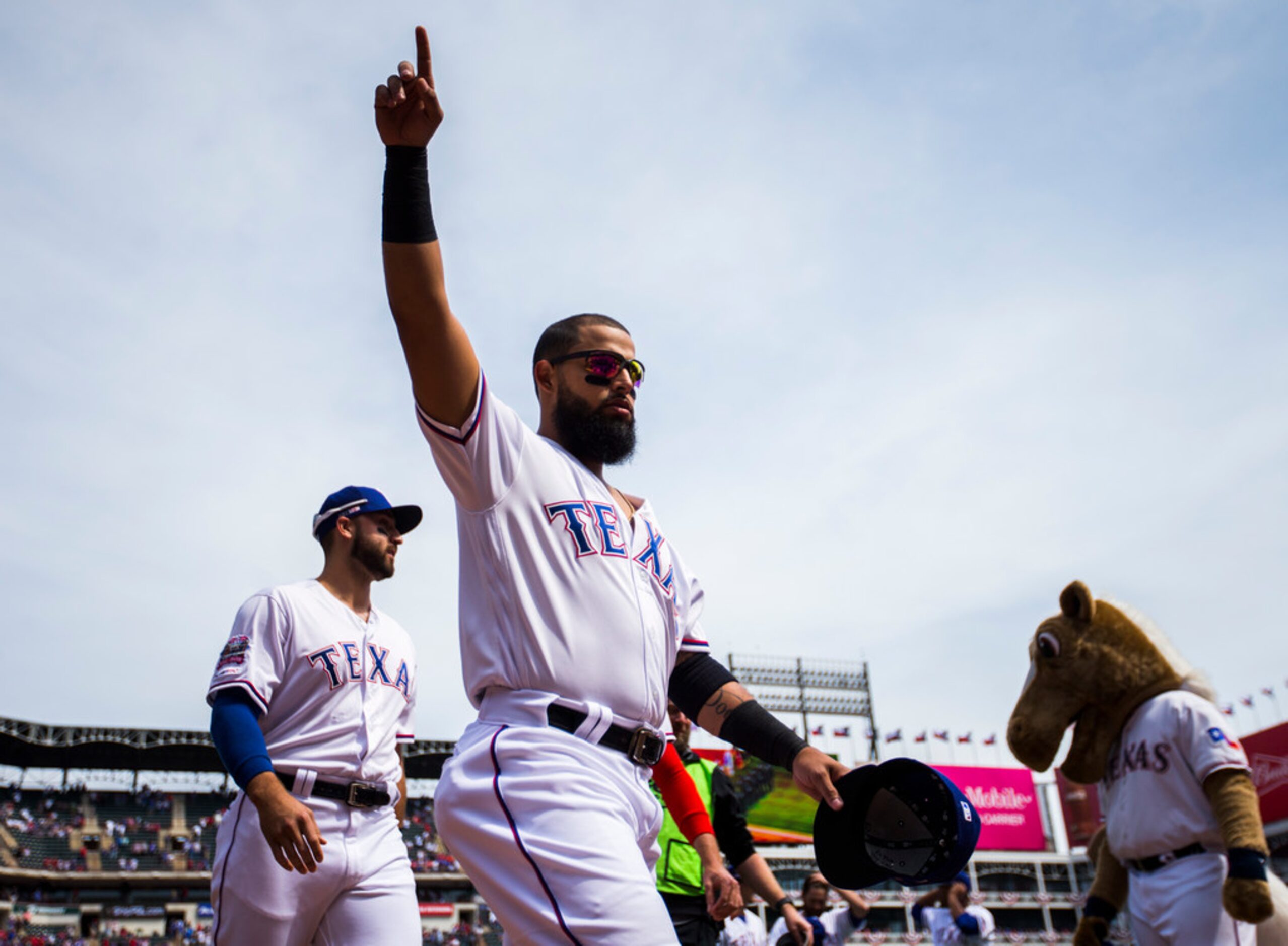 Texas Rangers second baseman Rougned Odor (12) points to fans before an opening day MLB game...