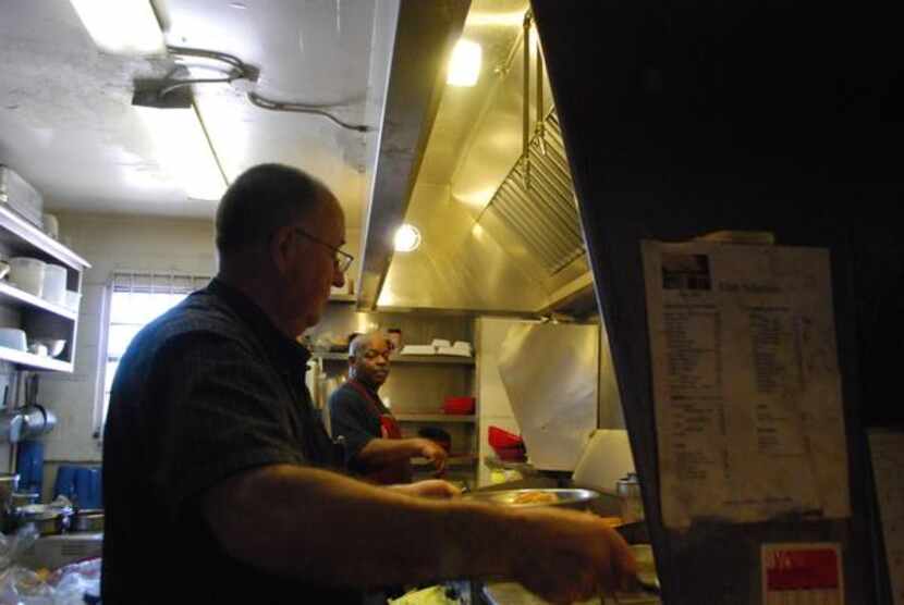 
Bob Schmitz (left) and Tony Lee work in the kitchen at Club Schmitz during a recent lunch...