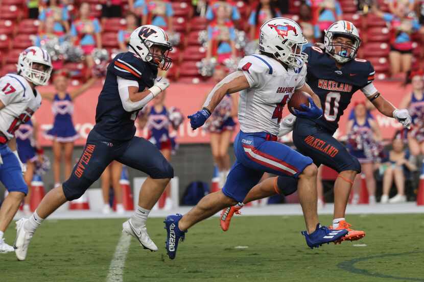 Grapevine High School’s Parker Polk (4) runs the ball into the end zone for a touchdown as...