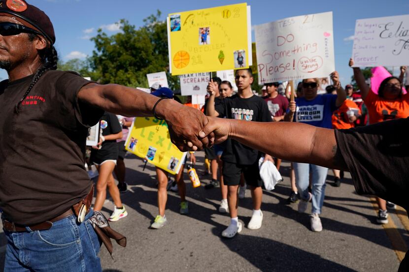 Escorted by the Texas Brown Berets, family and friends of those killed and injured in the...