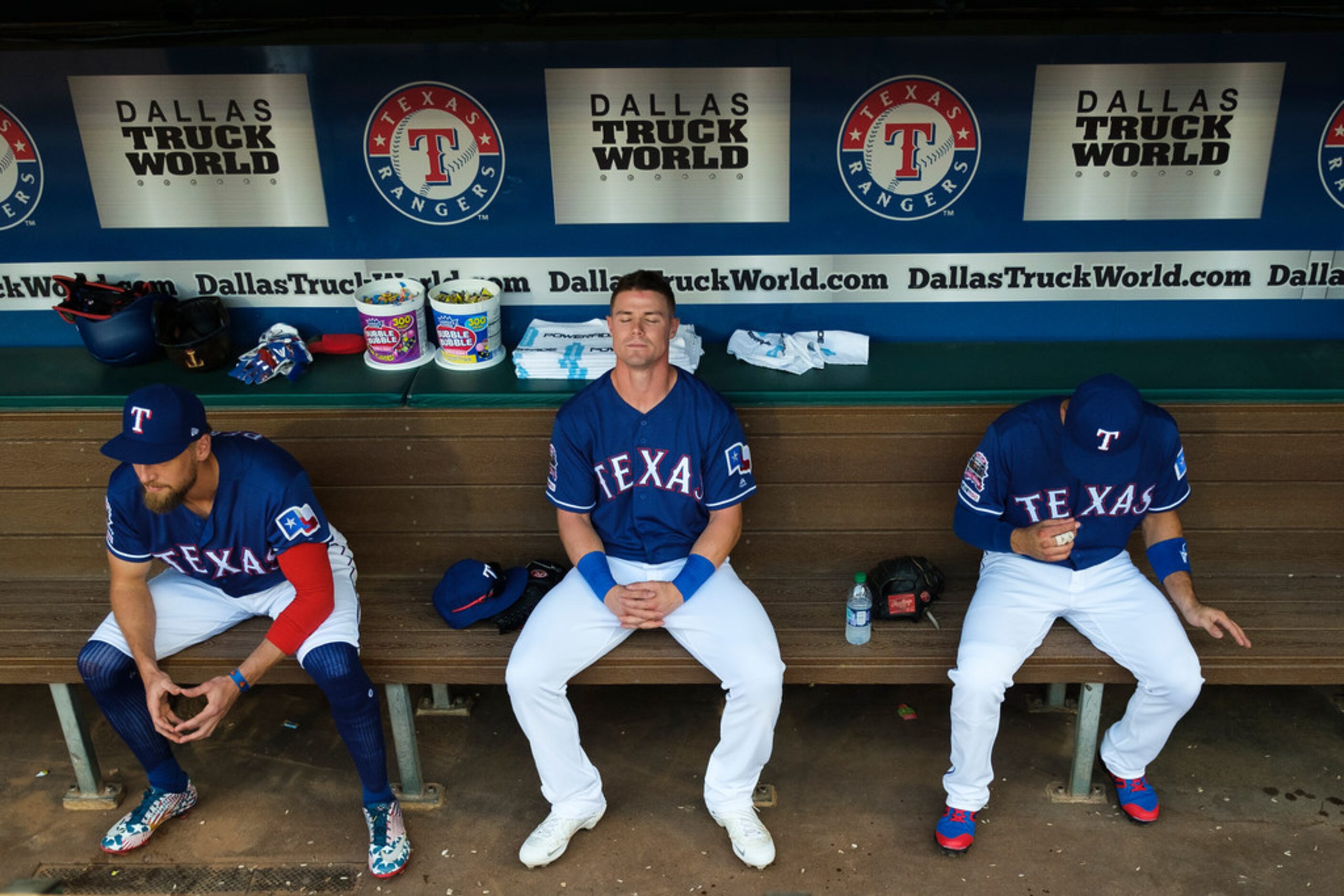 Texas Rangers outfielder Scott Heineman (center) collects himself in the dugout with Hunter...