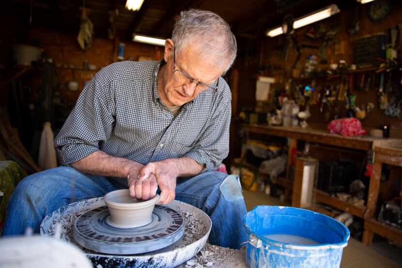 Bill Reed, a 74-year-old retiree, shapes a clay bowl in his garage workshop in Denton.