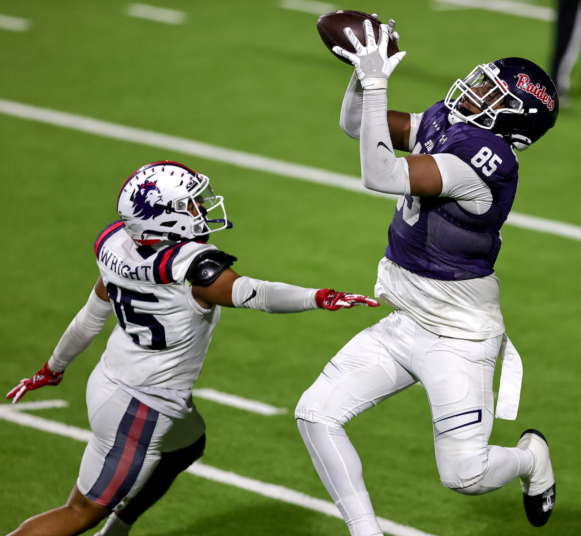 Denton Ryan half back Jose Melendez (85) goes up for a reception against Richland defensive...