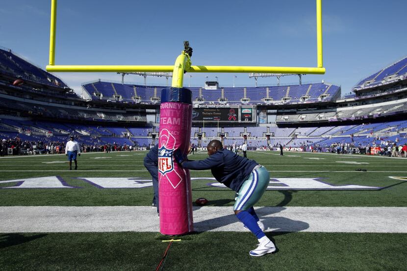 Dallas Cowboys defensive end Jay Ratliff (90) warms up on goal post during pre-game warm ups...