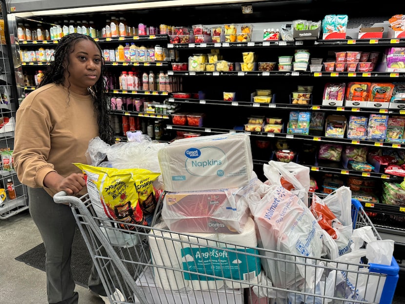 Roxanne Riley, 42, stocks up on supplies at a Walmart as she prepares to shelter in place in...