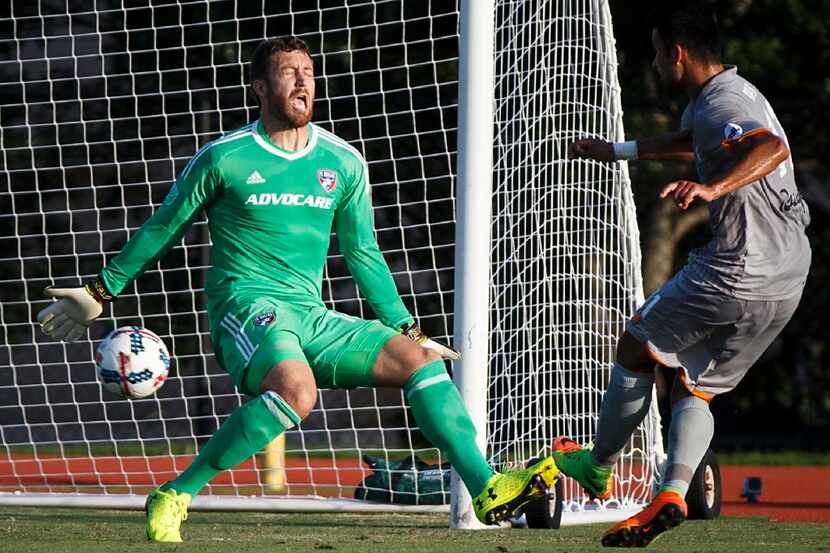 FC Dallas goalkeeper Chris Seitz makes a stop on Tulsa Roughnecks FC midfielder Joaquin...