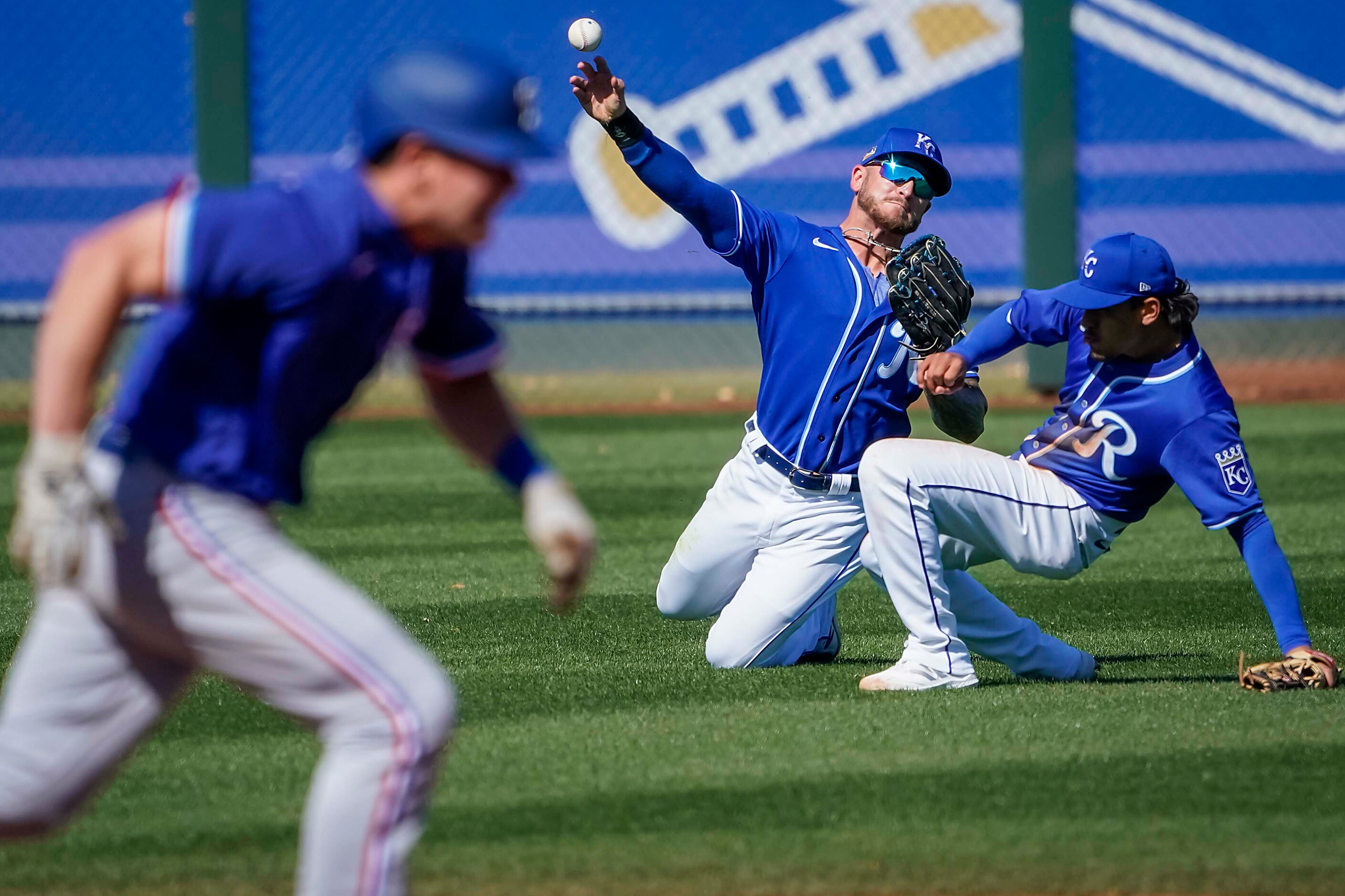 Kansas City Royals left fielder Kyle Isbel tries to double off Texas Rangers second baseman...